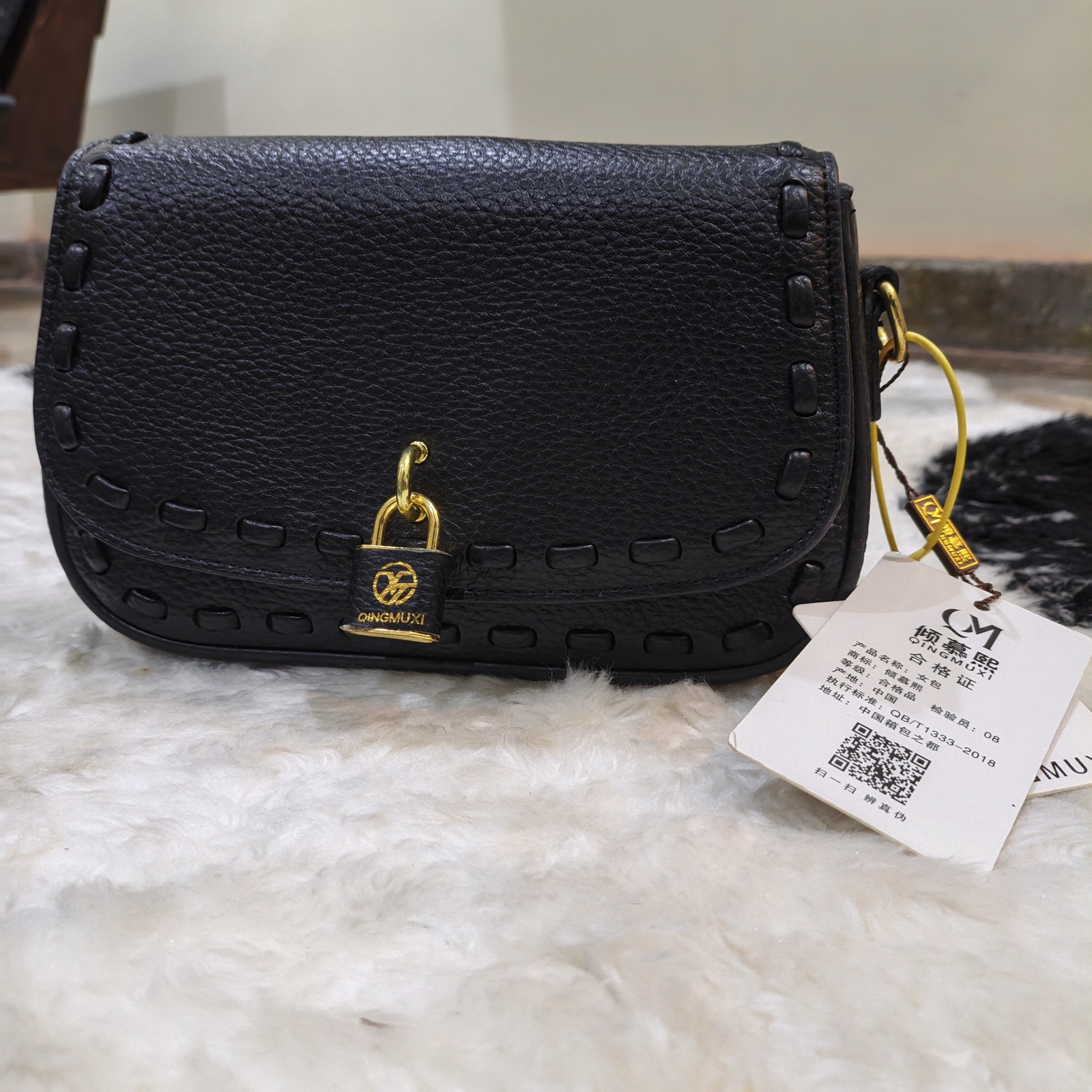 Women's Black Pebbled Flap Crossbody Bag with Padlock Charm & Guitar Strap